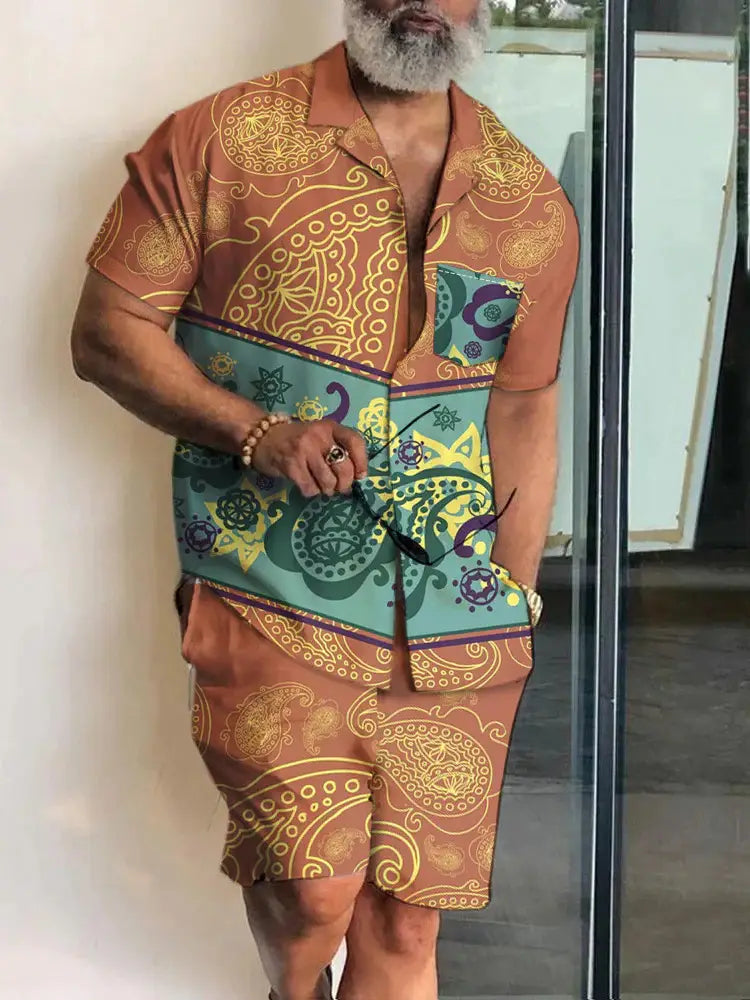 Men’s tropical print short sleeve shirt and shorts set featuring a brown and teal patterned button-up shirt with intricate gold, purple, and green paisley designs.