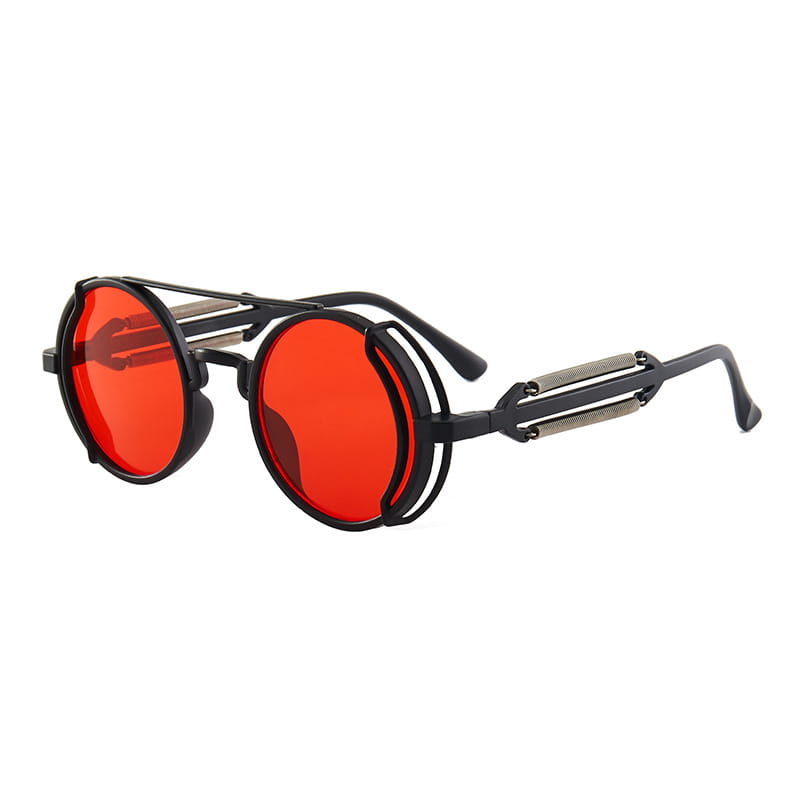 Gafas de sol steampunk redondas con monturas negras, lentes circulares rojas vibrantes y detalles metálicos en las patillas con doble resorte.
