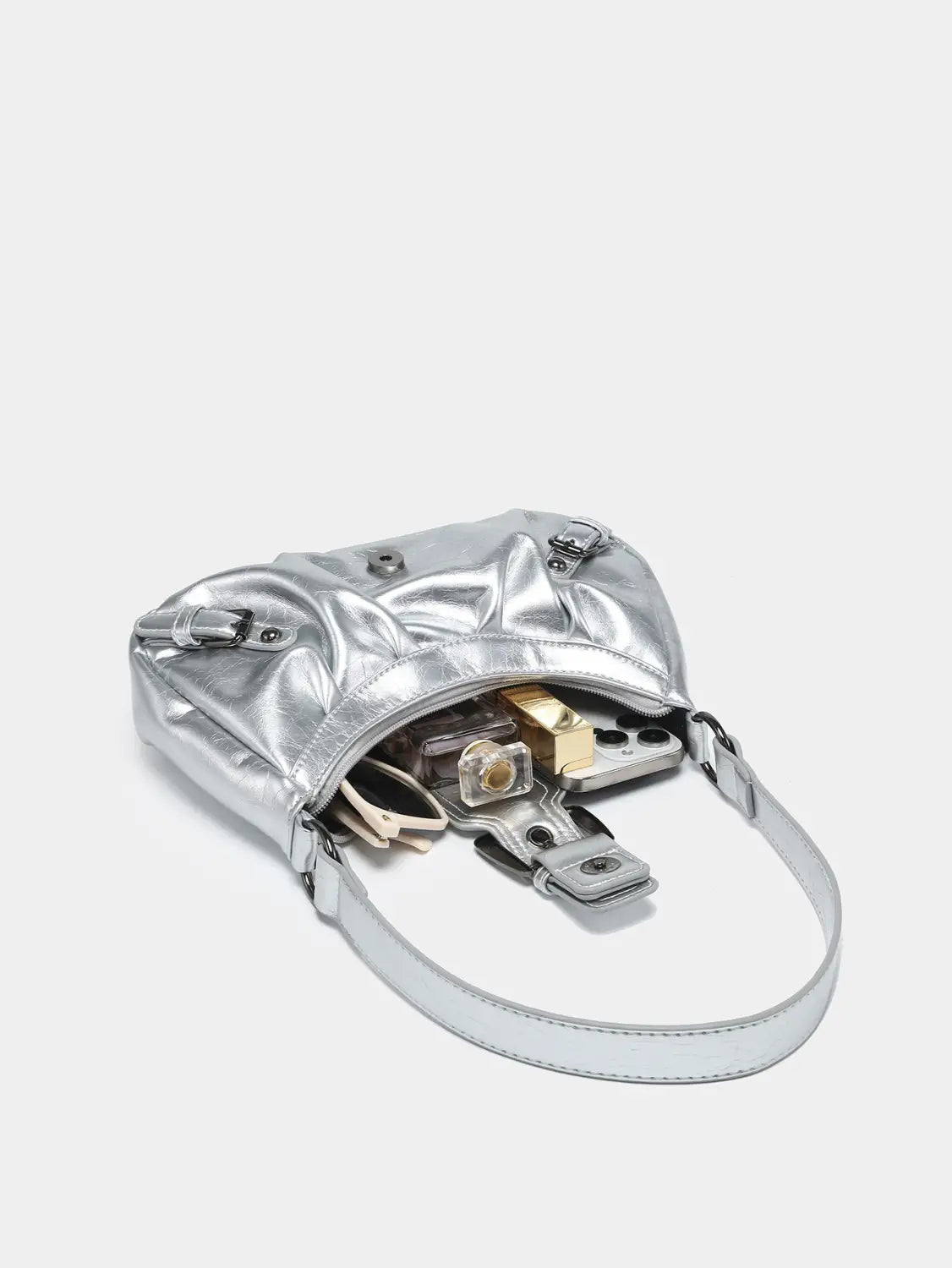 Vintage leather shoulder bag featuring a silver metallic quilted design with buckle details and an adjustable strap.