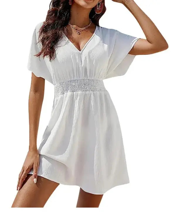 White v-neck short sleeve chiffon pleated dress with a smocked waistband shown from the front.