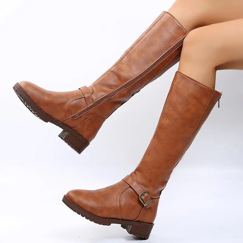 Brown leather knee high knight boots feature a buckle strap and zipper closure for secure wear.
