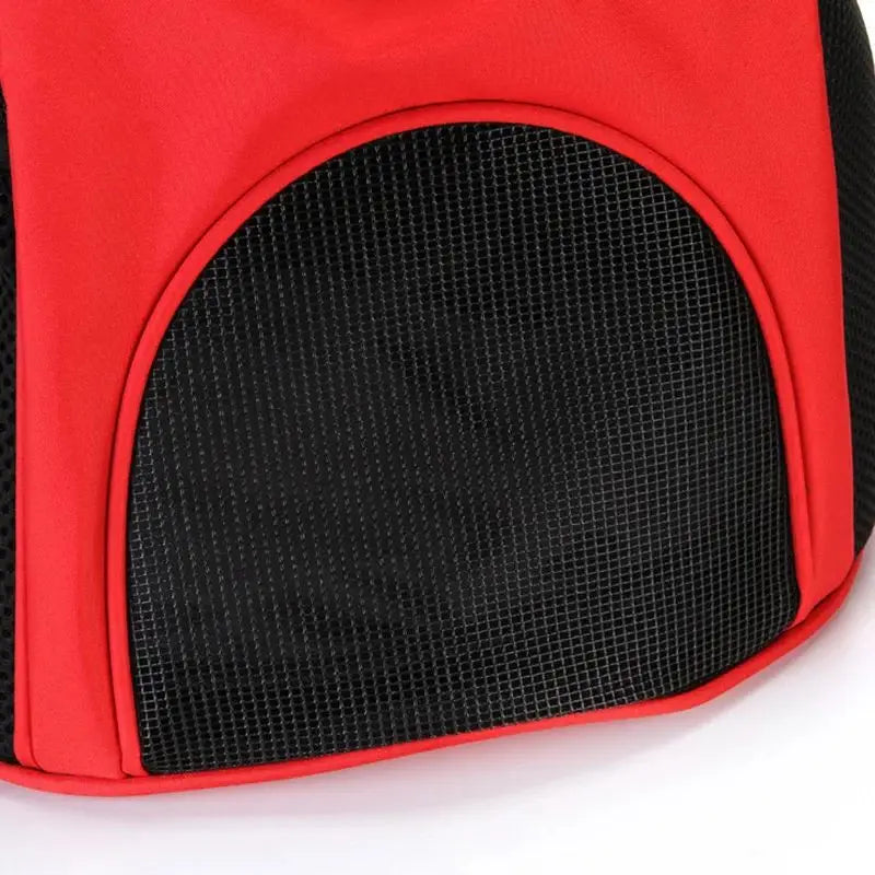 Red and black dog carrier backpack with breathable mesh panel for ventilation designed for small pet travel use.