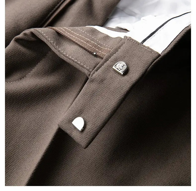 silver-toned buttonhole fasteners with subtle engraving on slim fit british style tailored straight leg trousers for men