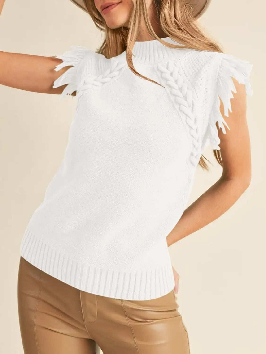 white hand-woven sleeveless knit sweater vest featuring fringed braided shoulder details and a soft knit texture.
