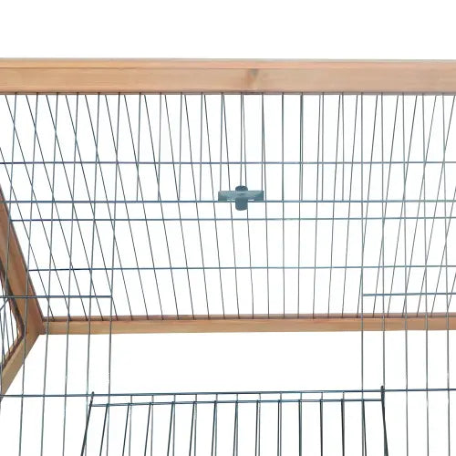 The back side of a wooden a-frame rabbit hutch outdoor small animal cage with galvanized metal wire mesh and light-colored wooden framing.