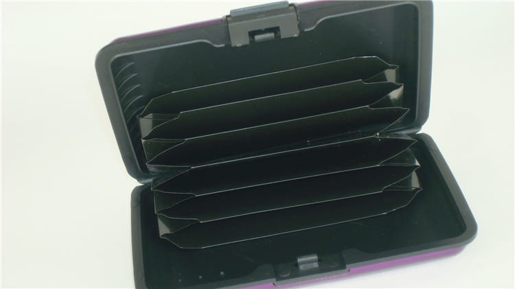 Purple and black rfid blocking aluminum alloy ribbed card holder case with five slots for cards.