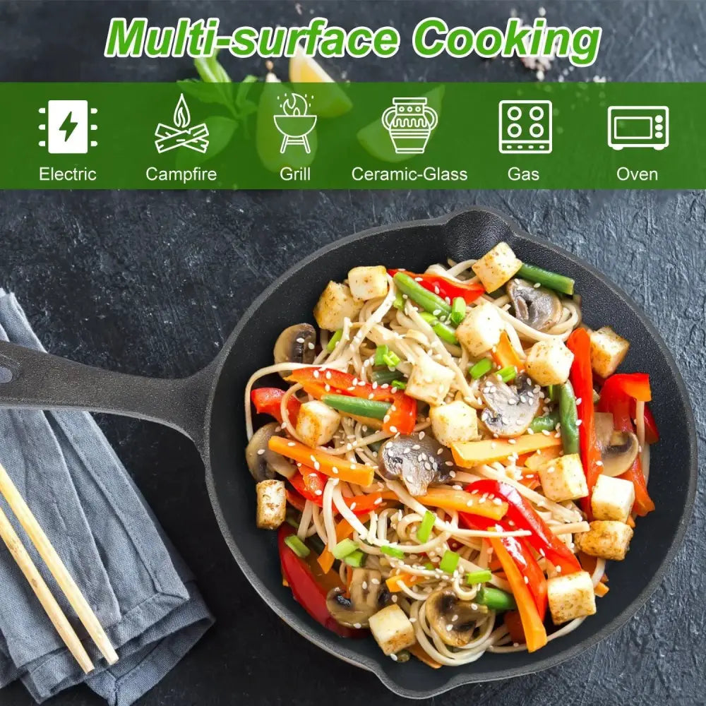 Black pre-seasoned cast iron skillet filled with colorful stir-fried noodles and vegetables from 3-piece set