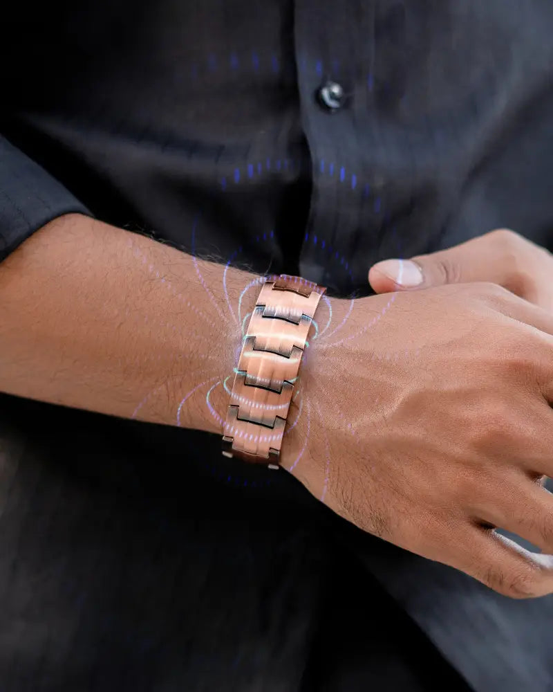 A sleek rose gold pure copper magnetic bracelet for men with a modern segmented metal design worn on a wrist