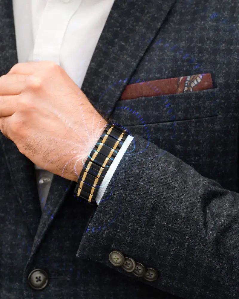 Triple strength black and gold titanium magnetic bracelet with sleek segmented design worn on the wrist