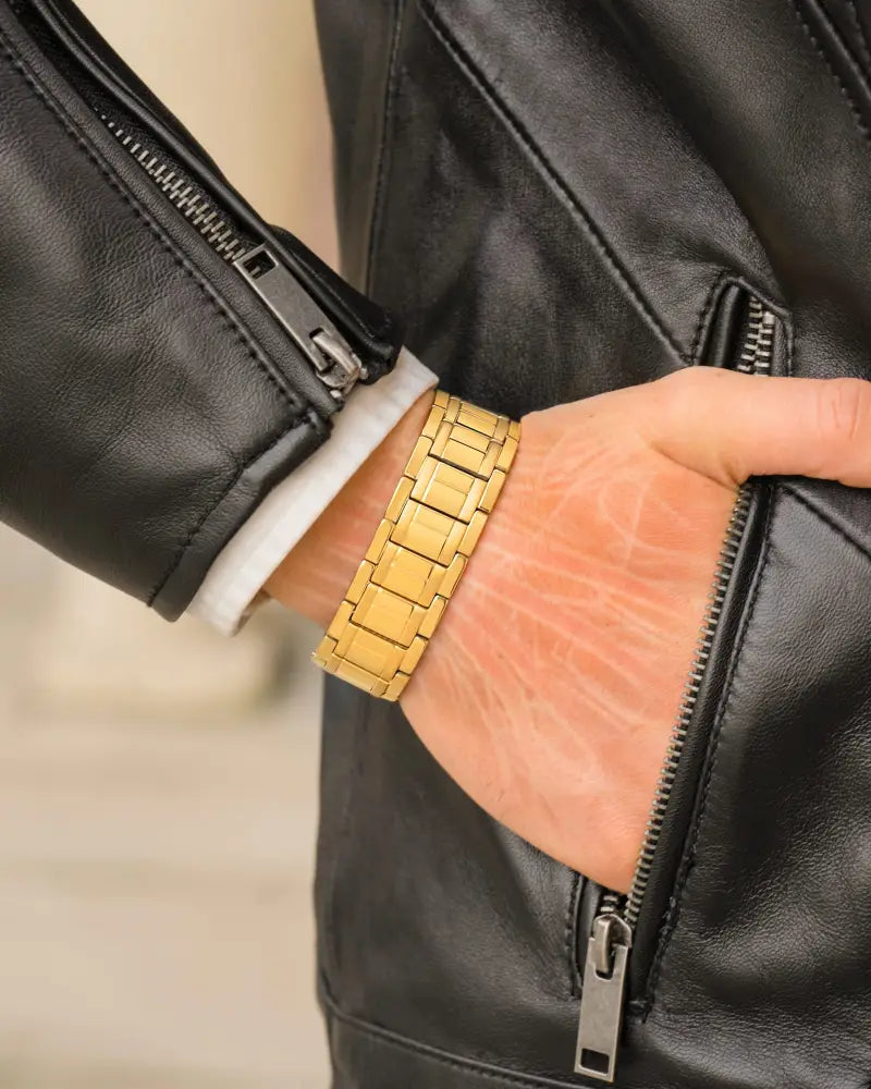 Men’s gold-tone titanium magnetic therapy bracelet with metal link watch band worn on wrist