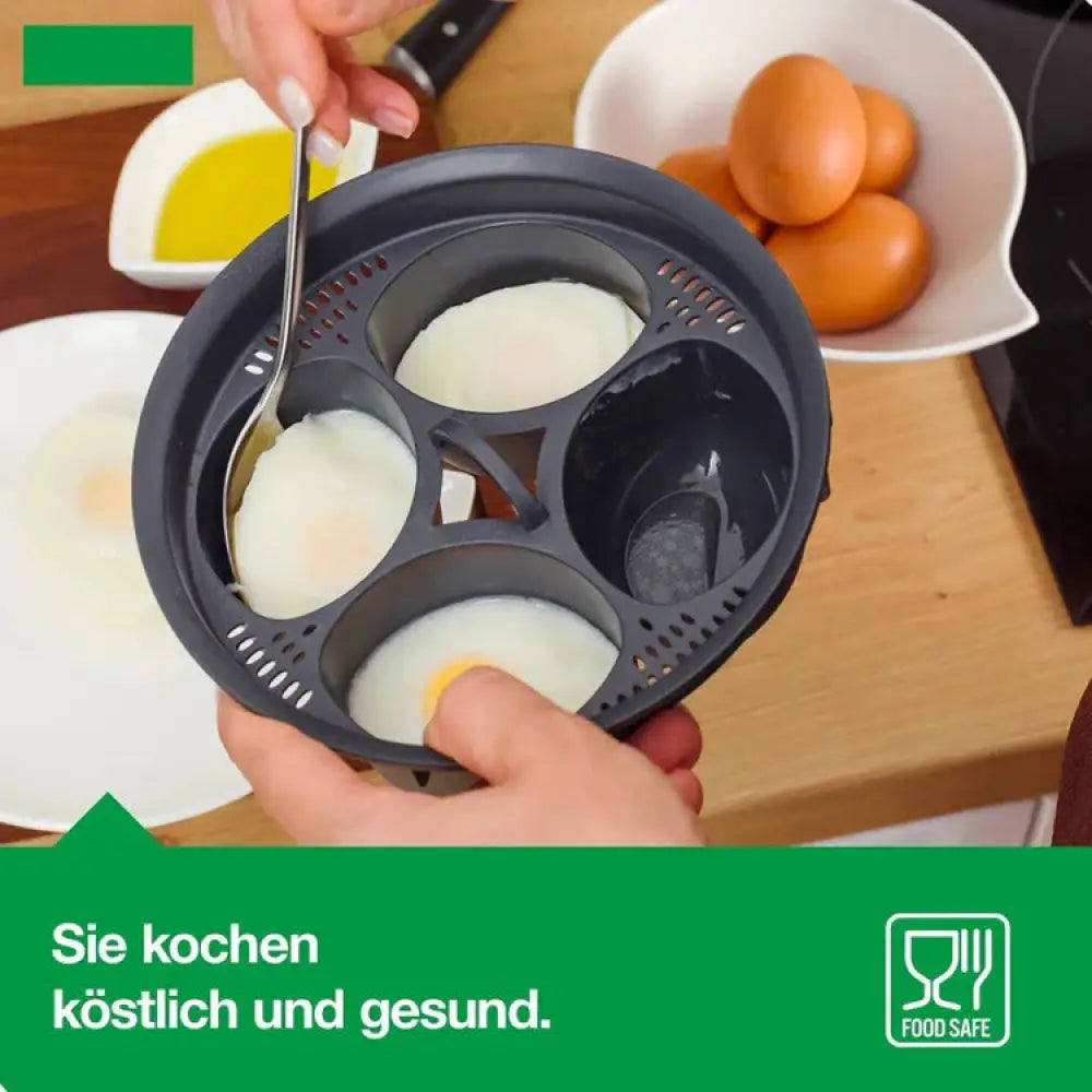 Black silicone 4-in-1 egg poacher and steamer mold set with four circular compartments holding poached eggs