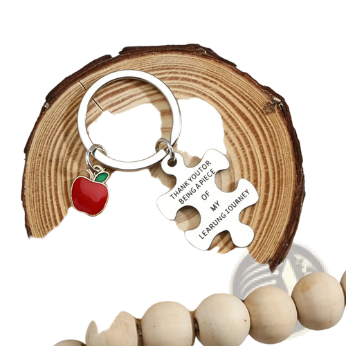 Silver stainless steel teacher appreciation keychain set with red enamel apple and engraved white puzzle-piece pendant