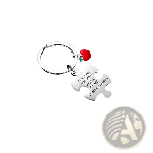 Silver stainless steel puzzle piece keychain with engraved message and small red apple charm for teacher appreciation