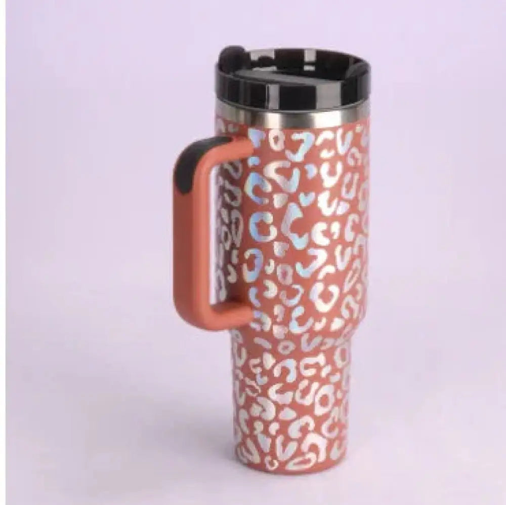 A terracotta-colored Arbaglobal 40 oz insulated travel mug with leopard print pattern and black lid for outdoor use