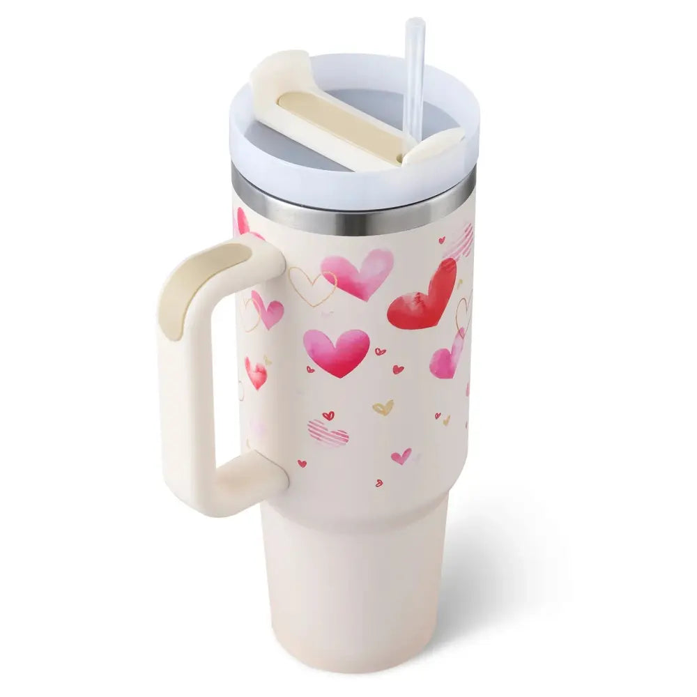 Cream-colored insulated tumbler with handle and straw featuring pink and red watercolor hearts by Arbaglobal