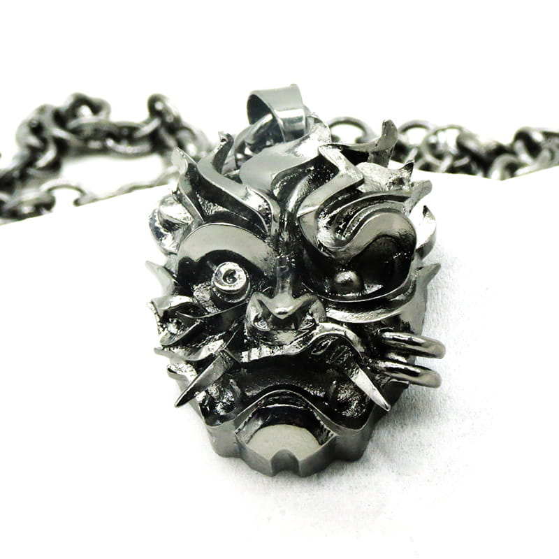 Blackened stainless steel pendant necklace shaped like a detailed menacing Japanese demon mask with sharp teeth and spiked features from the geometric wild game animal collection.