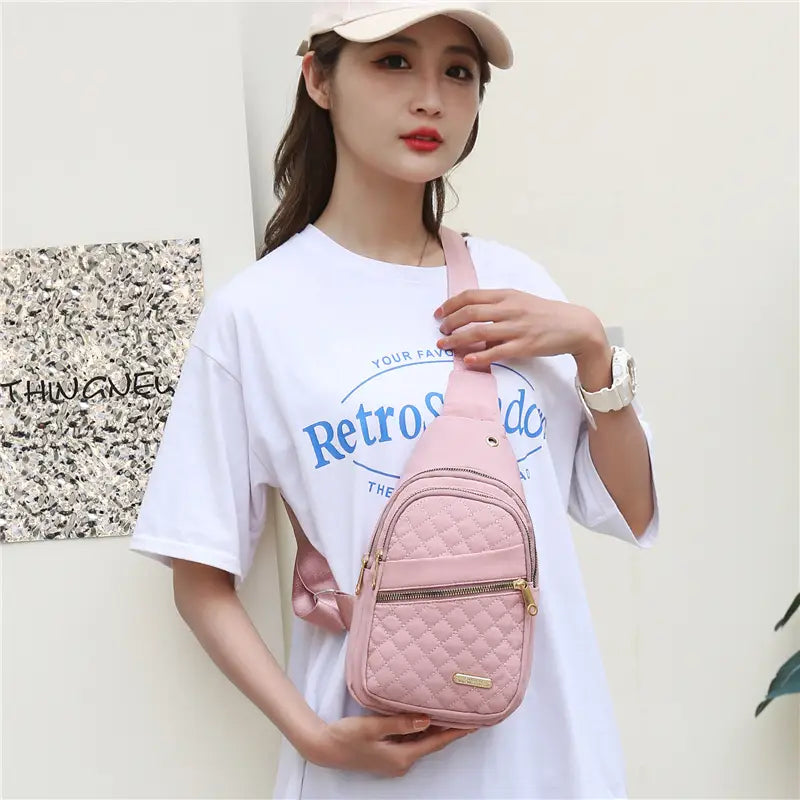 pink quilted crossbody slanted chest bag for women featuring gold-tone zipper and hardware
