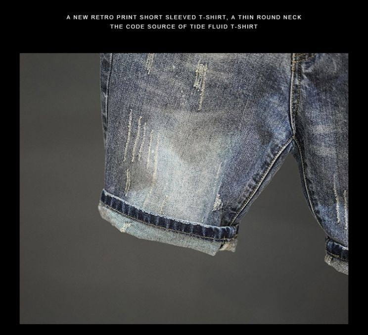 distressed maple leaf denim shorts featuring a distressed denim short-sleeved t-shirt with a faded blue wash and intentional frayed details