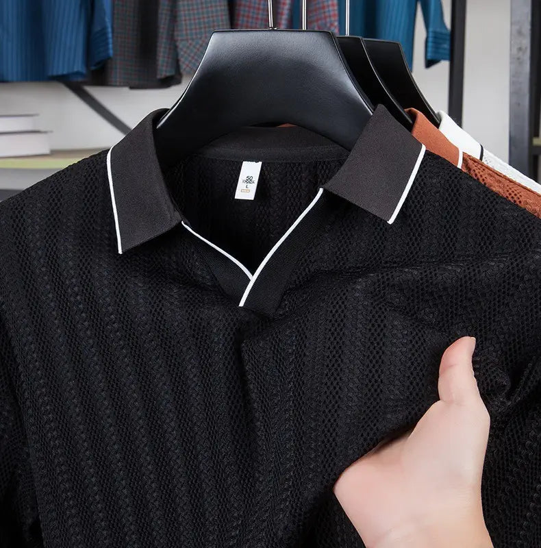 Men’s black textured ice silk knit polo shirt with contrasting white trim on the collar and placket.
