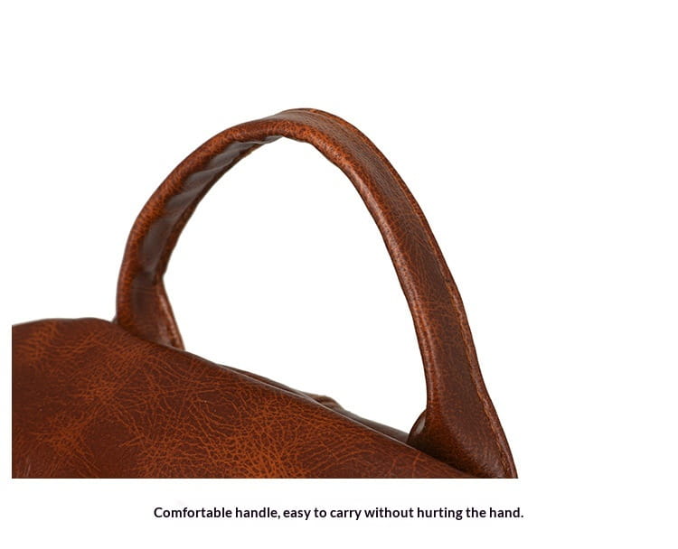 brown leather handle with a textured slightly distressed finish on a faux leather women’s large capacity commuter backpack