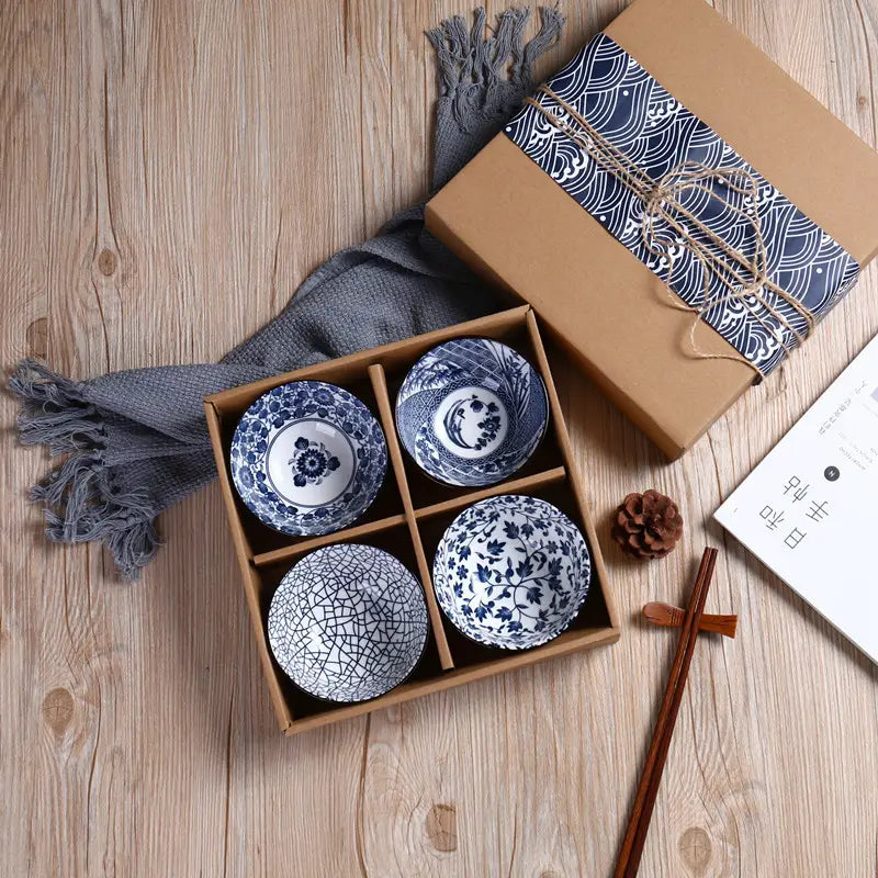 Set of four blue and white ceramic bowls with intricate floral and wave patterns displayed in a wooden gift box from the Japanese tableware set blue ceramic floral bowl 10 piece.