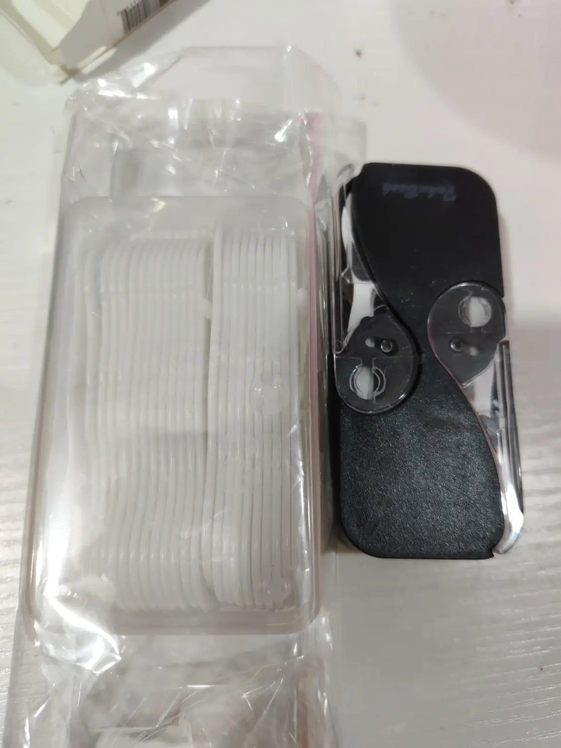 boîte de rangement pour fil dentaire avec étui à ouverture automatique, présentant un couteau utilitaire noir en plastique et métal avec une prise texturée, affiché à l’avant
