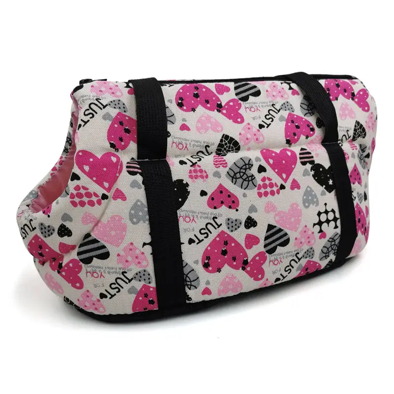 Warm pet carrier canvas fleece travel bag in pink and black with heart pattern and just you text on a white background.