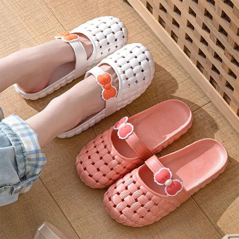 Woven bow slippers in white and pink featuring woven plastic material and cute bow decorations ideal for summer beach slide sandals.