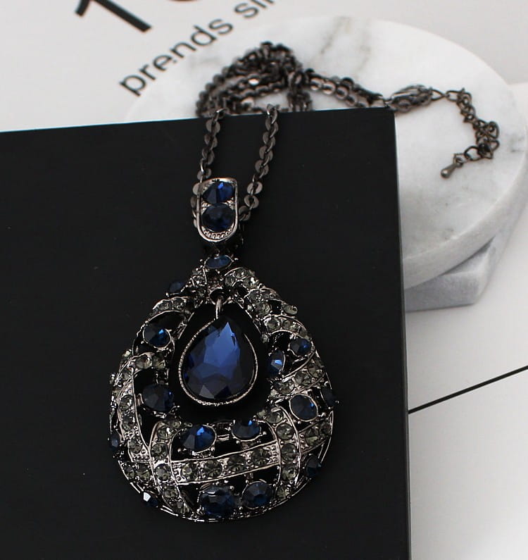 Elegant dark blue teardrop pendant necklace with intricate silver-toned filigree and sparkling rhinestones for Korean style sweater chain.