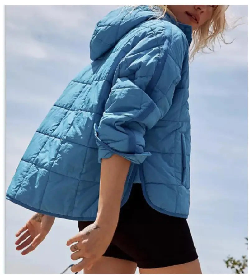 A light blue quilted hooded puffer jacket for women with rolled-up sleeves designed for warmth and style.
