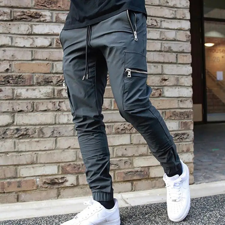 Men’s dark gray zipper cargo joggers casual pants featuring zippered pockets and a drawstring waistband.