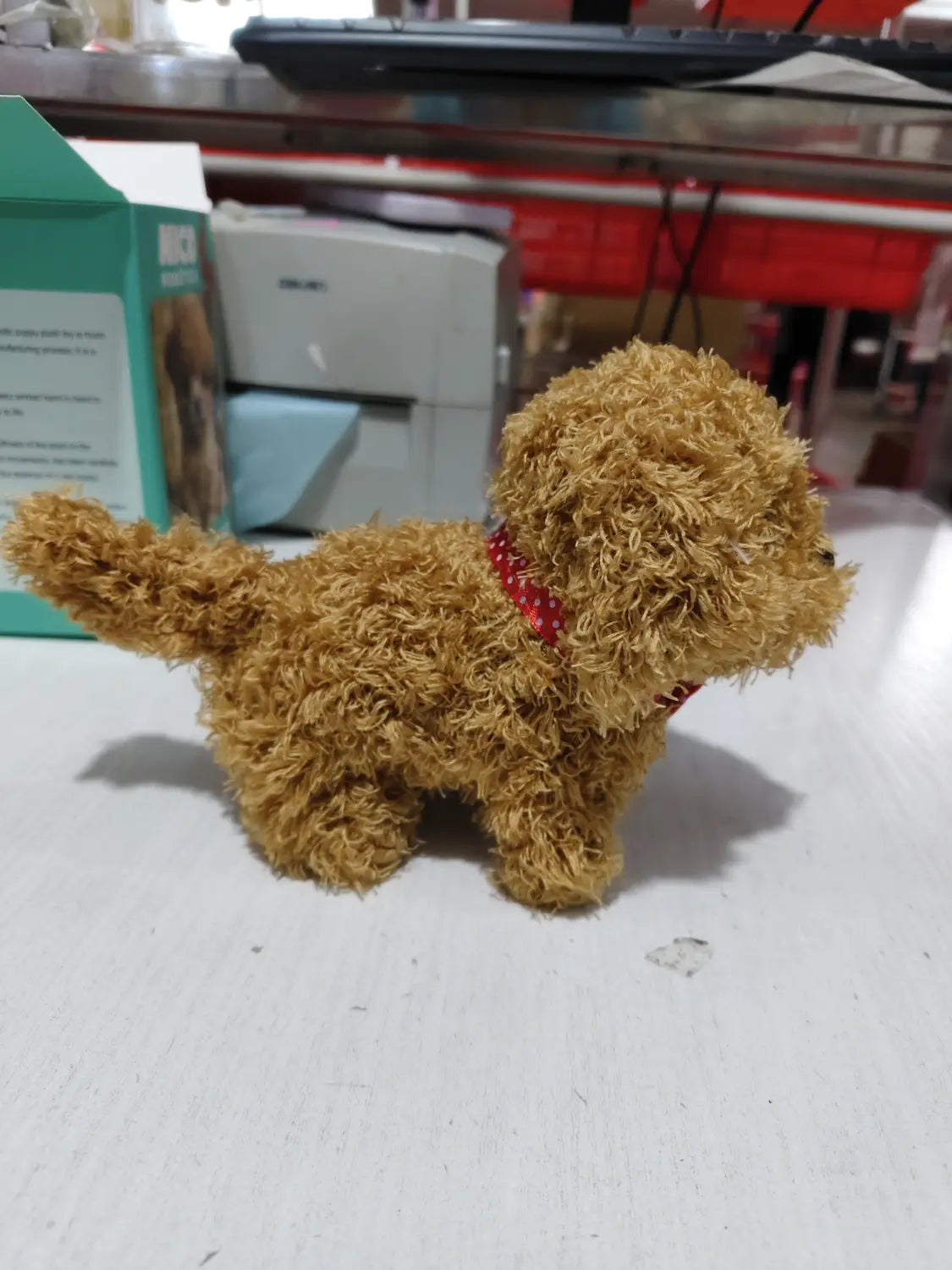a fluffy tan plush interactive robot puppy toy with sound and music wearing a red polka-dotted collar