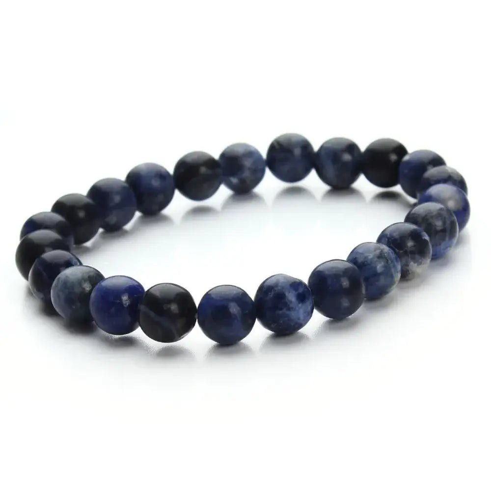 A natural polished gemstone and agate beaded bracelet featuring round polished sodalite stones in varying shades of deep blue and black.