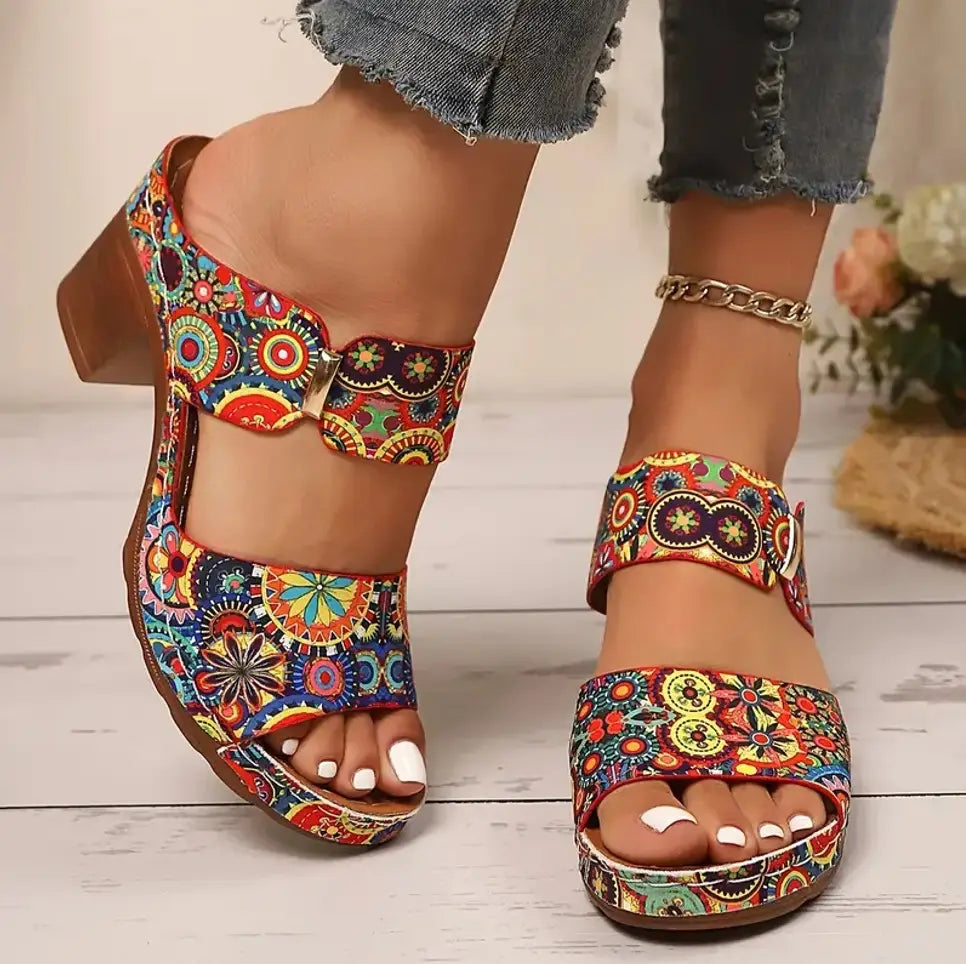 Colorful floral-patterned graffiti high heel slide sandals with an open toe, chunky heel, and adjustable buckle straps.