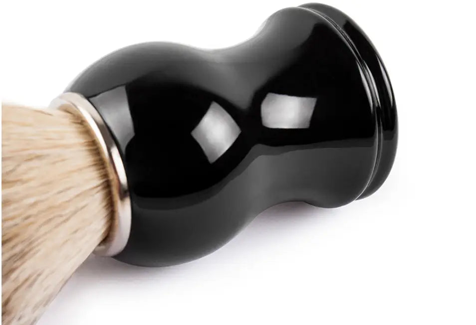 Black glossy ceramic badger hair shaving brush with natural bristles and silver metal ferrule for grooming.