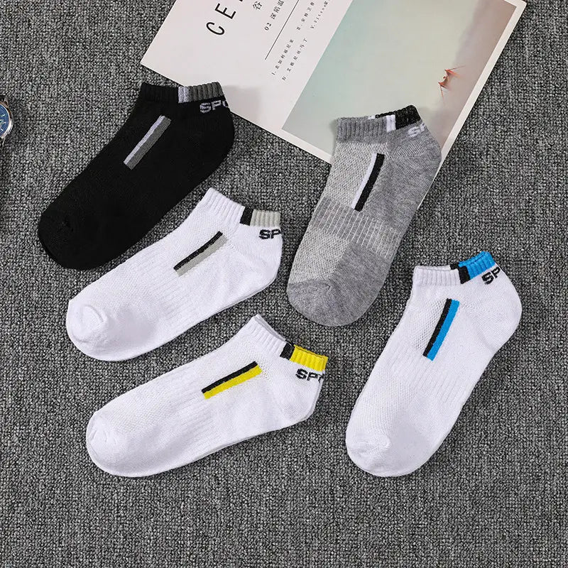 Set of four men’s low cut athletic striped cotton socks in black white and gray with sporty stripes and sp branding.