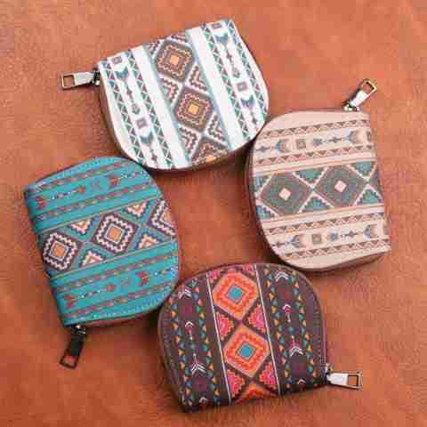 Four small woven geometric card wallets and portable coin purses with zippered closures featuring colorful teal white beige and brown patterns.