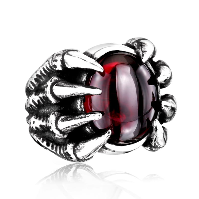 Silver claw ring featuring a prominent red zircon gemstone set in vintage titanium steel.
