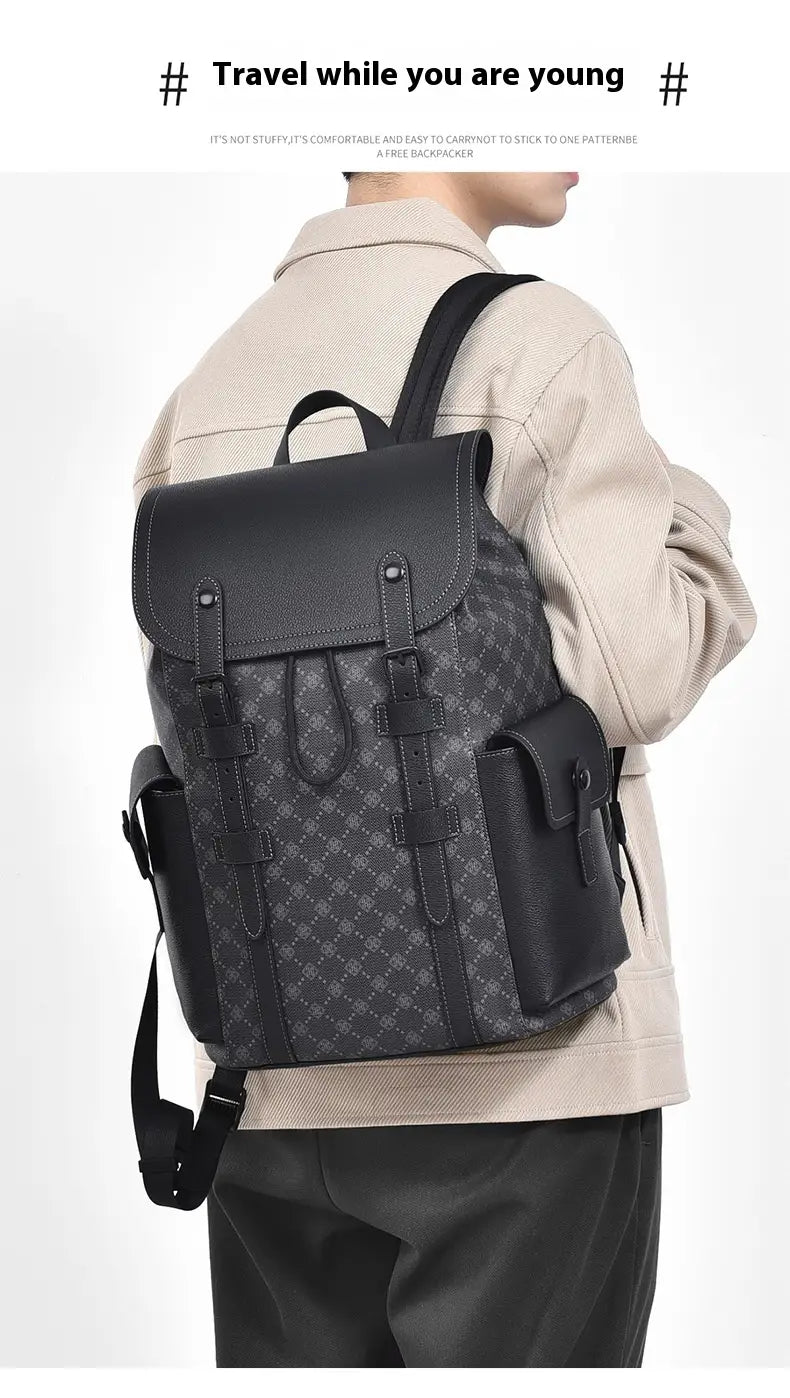 Men’s black leather business travel backpack with a subtle geometric pattern and sturdy straps featuring a laptop sleeve.