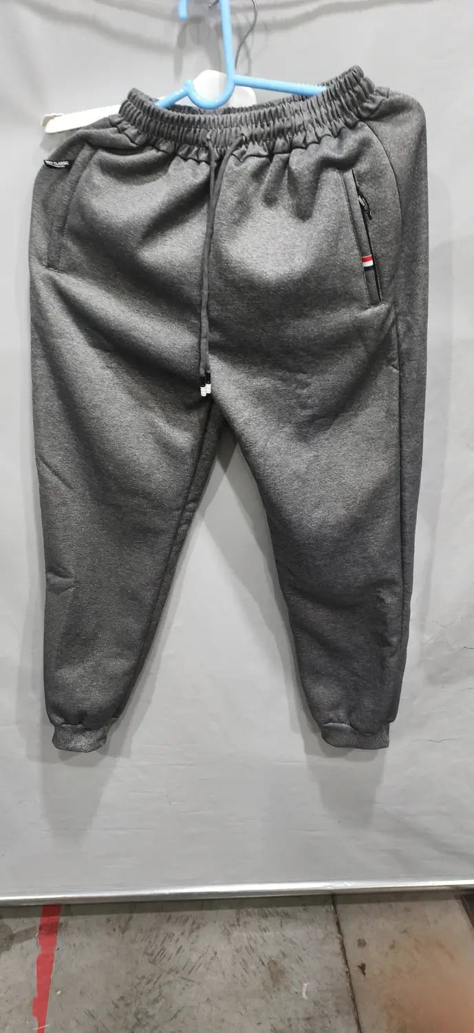 fleece lined mens winter jogger pants in gray featuring an elastic waistband with drawstring and side pockets with zipper closures