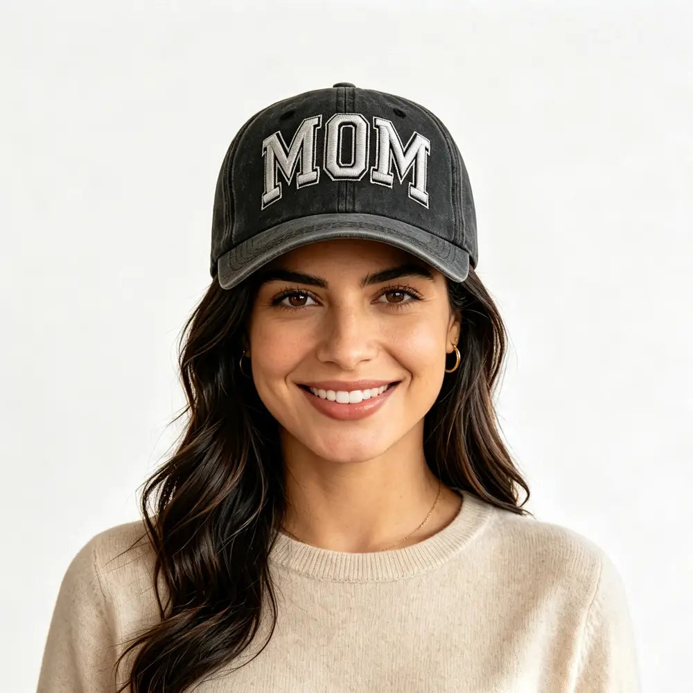 Black distressed baseball cap with embroidered white mom lettering in vintage washed fabric suitable for casual wear.