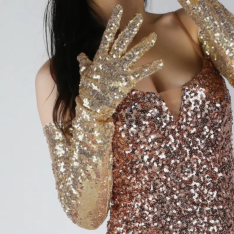 Shimmering gold sequined mesh finger gloves set featuring long sleek form-fitting design.
