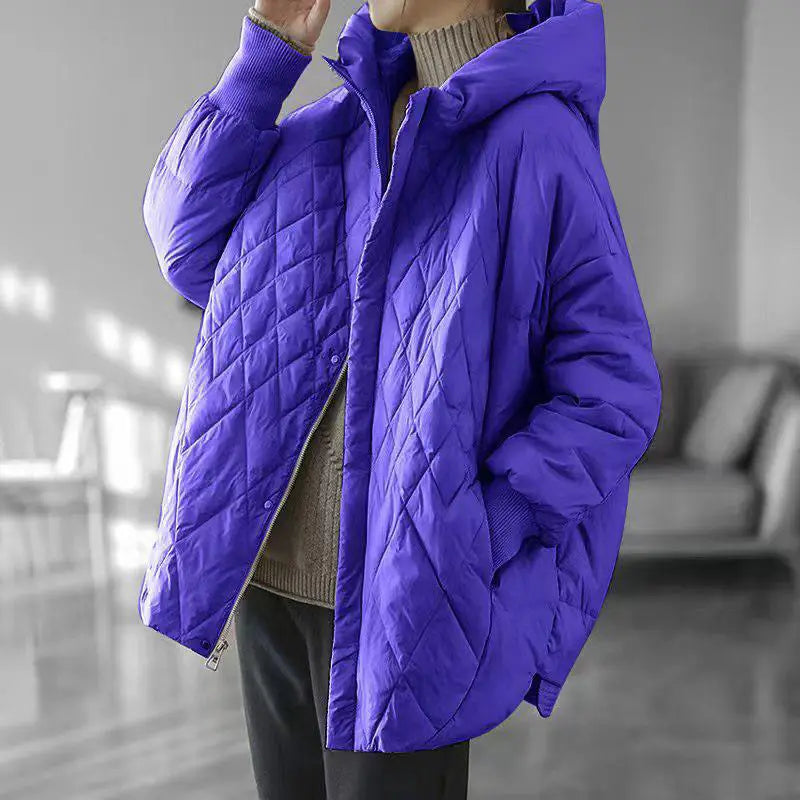 Vibrant purple quilted white duck down puffer jacket with a loose hooded design for winter use.