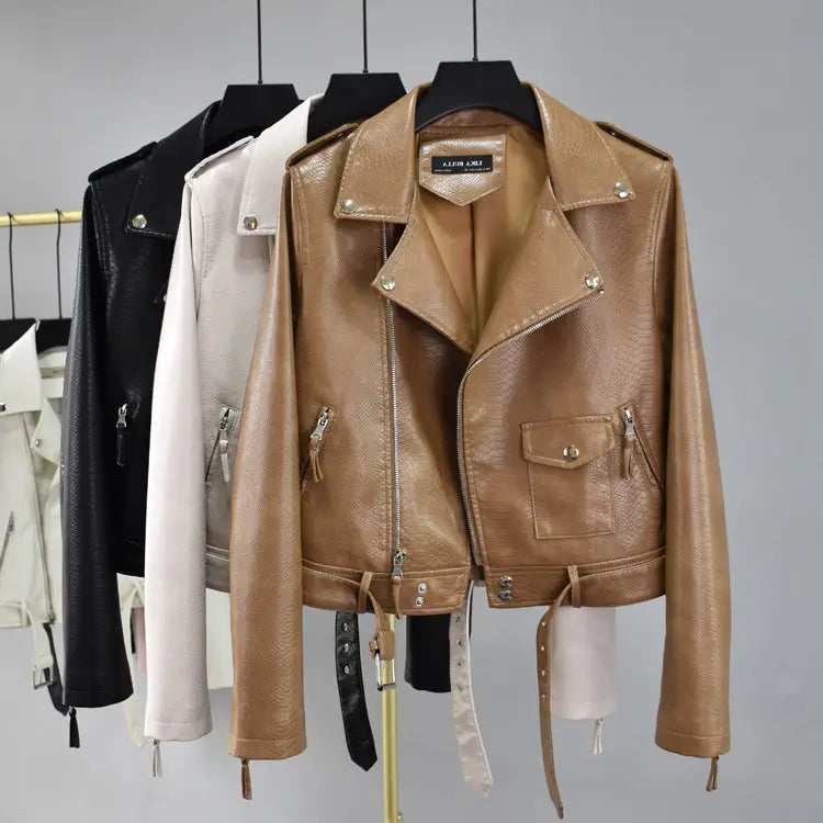 Tan crocodile faux leather cropped biker jacket with belt featuring a textured surface silver-toned hardware and classic collar design.