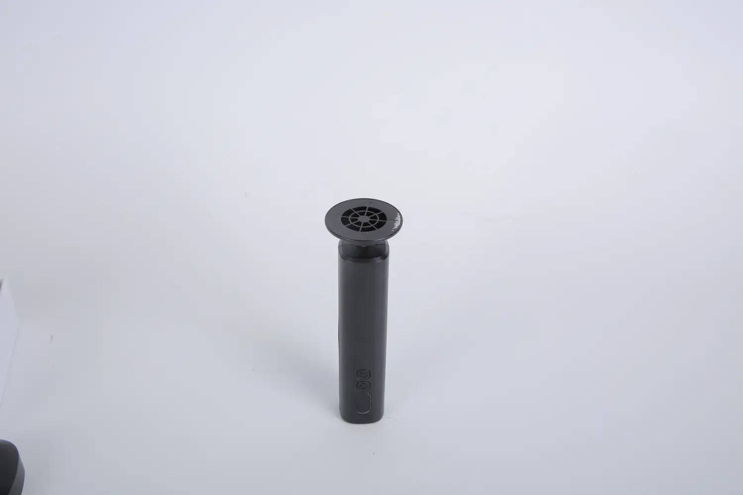 black cylindrical drain cover with circular grid pattern on top for electric foot callus remover and nail grinder kit