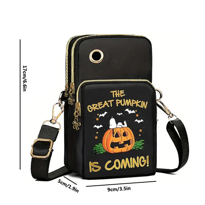 Black halloween-themed crossbody phone bag featuring an embroidered cartoon pumpkin with Snoopy, gold foil lettering the great pumpkin is coming, and decorative gold zipper pulls.