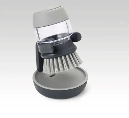Gray and black soap dispensing dish brush with clear container for soap, soft bristles, and non slip storage base for efficient dish cleaning.