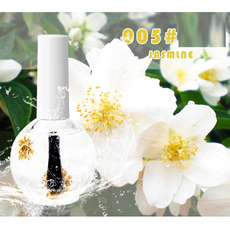 Bouteille en verre transparente de traitement huile revitalisant des fleurs séchées pour les ongles et les cuticules, parfumée au jasmin, avec bouchon blanc, pinceau noir et délicats motifs floraux dorés suspendus à l’intérieur du liquide.