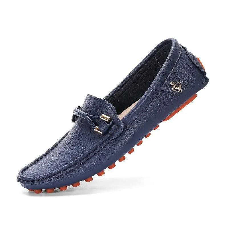 Navy blue leather men’s plus size driving moccasin loafer with textured surface, orange rubber sole, and metallic buckle detail.