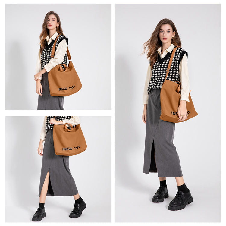 Tan canvas tote bag with high end large capacity black inside out lettering and wooden ring handles.